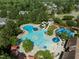 Aerial view of the community pool with various sections and amenities, surrounded by trees and lounge chairs at 282 Granite Mill Blvd, Chapel Hill, NC 27516