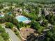 Aerial view of neighborhood pool, playground, and clubhouse surrounded by mature trees and well-maintained landscaping at 282 Granite Mill Blvd, Chapel Hill, NC 27516