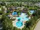 Aerial view of a luxurious community pool area with water slides, splash pad, and lounge chairs at 282 Granite Mill Blvd, Chapel Hill, NC 27516