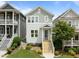 Charming two-story home with light-green and gray siding, complemented by a well-manicured lawn and inviting front porch at 282 Granite Mill Blvd, Chapel Hill, NC 27516