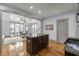 Open-concept kitchen with a granite island and modern appliances flowing into the living room at 282 Granite Mill Blvd, Chapel Hill, NC 27516