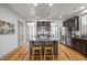 Well-lit kitchen with granite island, stainless appliances, wood cabinets, and hardwood floors at 282 Granite Mill Blvd, Chapel Hill, NC 27516