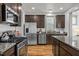 Modern kitchen with stainless steel appliances, granite countertops, and dark wood cabinets at 282 Granite Mill Blvd, Chapel Hill, NC 27516