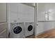 Laundry room featuring a side-by-side washer and dryer and wire rack shelving at 282 Granite Mill Blvd, Chapel Hill, NC 27516