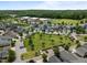 Aerial view of a lush neighborhood park surrounded by homes, featuring a soccer field and school building at 282 Granite Mill Blvd, Chapel Hill, NC 27516