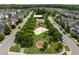 Aerial view of a charming community playground featuring a sandbox, swings, and covered picnic area at 282 Granite Mill Blvd, Chapel Hill, NC 27516