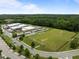 Aerial view of the school building with ample parking and a green athletic field in a well-kept community at 282 Granite Mill Blvd, Chapel Hill, NC 27516
