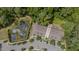 Aerial view of townhome complex nestled in a wooded area with a pond and parking at 3109 Stockdale Dr, Raleigh, NC 27609