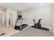 Spacious finished basement with home gym equipment and neutral carpeting provides ample recreational space at 3109 Stockdale Dr, Raleigh, NC 27609