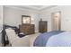 Well-lit bedroom with a crib, dresser, and rocking chair creates a cozy and functional space at 3109 Stockdale Dr, Raleigh, NC 27609