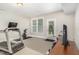 Basement exercise area with treadmill, stationary bike, and multiple windows for natural light at 3109 Stockdale Dr, Raleigh, NC 27609