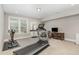 Basement exercise room featuring a treadmill, exercise bike, and natural light at 3109 Stockdale Dr, Raleigh, NC 27609