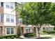 Townhome featuring a brick facade, stone accents, and lush landscaping at 3109 Stockdale Dr, Raleigh, NC 27609