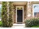A close-up of the front door with stone surround and landscaping at 3109 Stockdale Dr, Raleigh, NC 27609