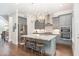 Modern kitchen with a large island, stainless steel appliances, and elegant light fixtures at 3109 Stockdale Dr, Raleigh, NC 27609