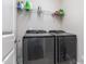 Well-organized laundry room with shelving and modern front load washer and dryer at 3109 Stockdale Dr, Raleigh, NC 27609