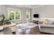 Cozy living room features hardwood floors, multiple windows, and comfortable seating at 3109 Stockdale Dr, Raleigh, NC 27609
