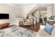 Open living space with hardwood floors, staircase, and view to dining and kitchen area at 3109 Stockdale Dr, Raleigh, NC 27609