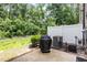 View of the outdoor patio with grill, privacy fence, and lush landscaping creating a relaxing outdoor space at 3109 Stockdale Dr, Raleigh, NC 27609