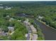An aerial view of the community surrounded by lush greenery and a beautiful lake at 313 Glen Echo Ln # J, Cary, NC 27518