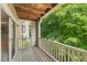 A spacious balcony with wooden floors offers a relaxing space to enjoy the surrounding nature at 313 Glen Echo Ln # J, Cary, NC 27518
