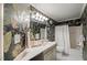 Bathroom featuring elegant floral wallpaper, a white vanity, and a shower-tub combo with a white shower curtain at 313 Glen Echo Ln # J, Cary, NC 27518