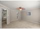 Bedroom view showing neutral carpet, a ceiling fan, and doorways to a hall and the bathroom at 313 Glen Echo Ln # J, Cary, NC 27518