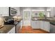 Charming kitchen with white cabinets and a seamless transition to the living area at 313 Glen Echo Ln # J, Cary, NC 27518