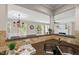 Open-concept kitchen with breakfast bar flowing into living space and natural light at 313 Glen Echo Ln # J, Cary, NC 27518