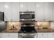 Modern kitchen with granite countertops and stainless steel appliances at 313 Glen Echo Ln # J, Cary, NC 27518