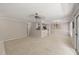 Spacious living area connects to a well-equipped kitchen and bright dining room with a modern ceiling fan at 313 Glen Echo Ln # J, Cary, NC 27518