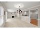 An open-concept living room offers a fireplace, access to a patio, and a view to the kitchen at 313 Glen Echo Ln # J, Cary, NC 27518