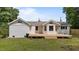 The home features a large wooden deck leading to a backyard, with a brick exterior and lush lawn at 314 Wrenn St, Apex, NC 27502
