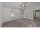 This light-filled bedroom features neutral walls, plush carpeting and multiple windows offering peaceful views at 314 Wrenn St, Apex, NC 27502