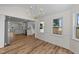 Bright dining area featuring a modern chandelier and views into the updated kitchen at 314 Wrenn St, Apex, NC 27502