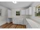 Bright kitchen with white cabinets, quartz countertops, ample storage, and modern flooring at 314 Wrenn St, Apex, NC 27502
