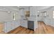 Bright, modern kitchen featuring white cabinets, quartz countertops, stainless steel appliances, and stylish gold hardware at 314 Wrenn St, Apex, NC 27502