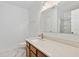 Bright bathroom features a quartz countertop and wood cabinets at 3141 Rapid Falls Rd, Cary, NC 27519