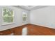 Bright bedroom with hardwood floors and two windows at 3141 Rapid Falls Rd, Cary, NC 27519