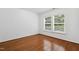 Bedroom featuring hardwood floors and two large windows at 3141 Rapid Falls Rd, Cary, NC 27519
