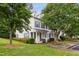 Inviting townhome with manicured lawn, colorful landscaping, and classic architectural details at 3141 Rapid Falls Rd, Cary, NC 27519
