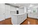 Spacious kitchen with white cabinetry, large island, and stainless steel appliances at 3141 Rapid Falls Rd, Cary, NC 27519