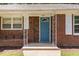 Close-up of the front entrance featuring a light blue door and decorative white iron columns at 408 N Stewart St, Clayton, NC 27520