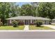 Charming single-story brick home featuring a well-maintained front yard and a bright blue front door at 408 N Stewart St, Clayton, NC 27520
