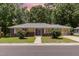 Single story brick home featuring green lawn, sidewalk and flower bushes at 408 N Stewart St, Clayton, NC 27520