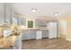 Efficient kitchen layout with gray cabinets, modern appliances, and durable wood-look flooring at 408 N Stewart St, Clayton, NC 27520