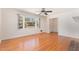 Bright and spacious living room with hardwood floors, a large window, and a ceiling fan at 408 N Stewart St, Clayton, NC 27520