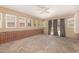Bright sunroom featuring multiple windows, carpet flooring, and a brick half wall at 408 N Stewart St, Clayton, NC 27520