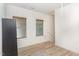 Bright bedroom with light wood floors, two windows, and access to stairs at 425 Liberty Hill, Morrisville, NC 27560