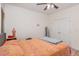 Bedroom featuring a bed with an orange paisley comforter and double door closet at 425 Liberty Hill, Morrisville, NC 27560